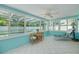 Bright sunroom with tiled floors, many windows, and a table and chairs to relax in at 1101 Mclean St, Dunedin, FL 34698
