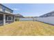 Expansive backyard featuring a white fence and grass at 11109 Carrick Stone St, Wimauma, FL 33598
