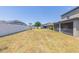 Large grass backyard surrounded by a white privacy fence at 11109 Carrick Stone St, Wimauma, FL 33598