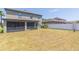 Large backyard featuring a screen patio and grass at 11109 Carrick Stone St, Wimauma, FL 33598