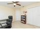 Neutral carpeted bedroom features a ceiling fan, closet, and decor at 11109 Carrick Stone St, Wimauma, FL 33598