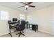 Neutral bedroom features a ceiling fan, carpeted floor, and a window providing natural light at 11109 Carrick Stone St, Wimauma, FL 33598