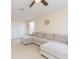 Large bonus room featuring a sectional sofa, ceiling fan, and natural light at 11109 Carrick Stone St, Wimauma, FL 33598
