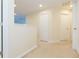 Bright hallway with carpet and doorways at 11109 Carrick Stone St, Wimauma, FL 33598