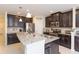 Beautiful kitchen with granite countertops, stainless steel appliances, and dark cabinetry at 11109 Carrick Stone St, Wimauma, FL 33598