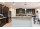 Modern kitchen featuring stainless appliances, granite counters, and a breakfast bar at 11109 Carrick Stone St, Wimauma, FL 33598