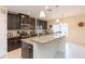 Modern kitchen with dark wood cabinets, stainless steel appliances, and granite countertops at 11109 Carrick Stone St, Wimauma, FL 33598
