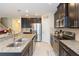 Gourmet kitchen with granite countertops, stainless steel appliances, and dark wood cabinets at 11109 Carrick Stone St, Wimauma, FL 33598