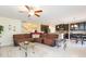 Spacious living room and kitchen combination with a large sofa at 11109 Carrick Stone St, Wimauma, FL 33598
