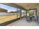 Comfortable screened patio with ceiling fan and backyard view and dining set at 11109 Carrick Stone St, Wimauma, FL 33598