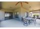 Cozy screened patio with ceiling fan, and outdoor dining set at 11109 Carrick Stone St, Wimauma, FL 33598