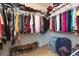 Spacious walk-in closet featuring multiple rows of clothing racks, shelving, and storage with carpeted floors at 11109 Carrick Stone St, Wimauma, FL 33598