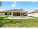 Backyard featuring a swimming pool, patio, and lush landscaping at 11845 Newberry Grove Loop, Riverview, FL 33579