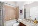 This bathroom boasts tile, tub, shower, toilet, vanity, granite countertop and modern fixtures at 11845 Newberry Grove Loop, Riverview, FL 33579