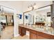 Bathroom featuring double sinks, granite countertop, and a large mirror at 11845 Newberry Grove Loop, Riverview, FL 33579