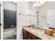 Bathroom featuring a shower-tub combo and granite counter tops at 11845 Newberry Grove Loop, Riverview, FL 33579