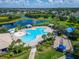 Aerial view of community pool with beach entry, playground and lake views at 11845 Newberry Grove Loop, Riverview, FL 33579