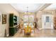Formal dining room featuring neutral paint, tile floors, large window, and decorative cabinet at 11845 Newberry Grove Loop, Riverview, FL 33579