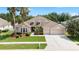 Charming single-story home with a well-manicured lawn, mature landscaping, and a two-car garage at 11845 Newberry Grove Loop, Riverview, FL 33579
