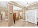Elegant foyer with tile flooring, decorative columns, and a view into the dining area at 11845 Newberry Grove Loop, Riverview, FL 33579