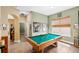 Spacious game room featuring a pool table, large window, and neutral-toned walls at 11845 Newberry Grove Loop, Riverview, FL 33579