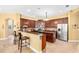 Spacious kitchen with granite countertops, stainless steel appliances, an island and breakfast bar at 11845 Newberry Grove Loop, Riverview, FL 33579