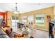 Bright living room featuring tile flooring, contemporary furnishings, and views of the outdoor pool at 11845 Newberry Grove Loop, Riverview, FL 33579
