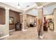 Open-concept living area with tile floors, decorative columns, and comfortable leather furniture at 11845 Newberry Grove Loop, Riverview, FL 33579