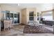 Covered patio with outdoor seating and sliding glass doors to backyard at 11845 Newberry Grove Loop, Riverview, FL 33579