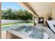 Backyard with a pool, hot tub, and covered patio at 11845 Newberry Grove Loop, Riverview, FL 33579
