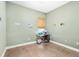 An empty room with a window, green walls, neutral trim, and tiled floor offers versatility at 11845 Newberry Grove Loop, Riverview, FL 33579