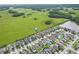 Expansive aerial view of a residential area near a lake and green fields at 11871 Crestridge Loop, Trinity, FL 34655