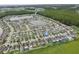 A scenic aerial view of a housing community with lakes and lush green surroundings at 11871 Crestridge Loop, Trinity, FL 34655
