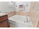 Bathroom featuring a soaking tub with decorative tile surround at 11871 Crestridge Loop, Trinity, FL 34655