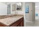 Bathroom featuring granite countertops, a decorative mirror and ample lighting at 11871 Crestridge Loop, Trinity, FL 34655
