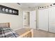 Bedroom featuring a closet, doorway, and neutral decor with a moon phases picture at 11871 Crestridge Loop, Trinity, FL 34655