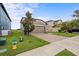 Two-story home with a brick driveway, two-car garage, and manicured lawn at 11871 Crestridge Loop, Trinity, FL 34655