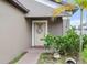 Close-up of front door, highlighting the inviting entrance with a decorative wreath and manicured greenery at 11871 Crestridge Loop, Trinity, FL 34655