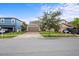 Well-manicured lawn and brick driveway leading up to this lovely home with a two car garage and mature landscaping at 11871 Crestridge Loop, Trinity, FL 34655