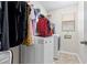 Bright laundry room with a front load washer and dryer near a window at 11871 Crestridge Loop, Trinity, FL 34655