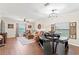 Spacious living room featuring wood floors, a ceiling fan, and a decorative light fixture at 11871 Crestridge Loop, Trinity, FL 34655