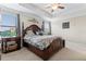 Comfortable main bedroom with tray ceiling, and dark wood furniture at 11871 Crestridge Loop, Trinity, FL 34655
