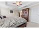 Spacious main bedroom with dark wood furniture, and ensuite bath access at 11871 Crestridge Loop, Trinity, FL 34655