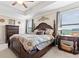 Spacious main bedroom with tray ceiling, dark wood furniture, and natural light at 11871 Crestridge Loop, Trinity, FL 34655