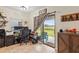 Cozy office space with a sliding glass door and views of the yard at 11871 Crestridge Loop, Trinity, FL 34655