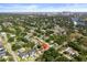 Aerial view of a home in a residential area, with trees and a skyline in the distance at 1209 W Adalee St, Tampa, FL 33603