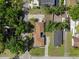 Aerial view of a charming home with a well-maintained lawn and nearby trees at 1209 W Adalee St, Tampa, FL 33603
