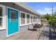 Charming backyard deck with comfortable seating, lovely landscaping, and a vibrant turquoise door at 1209 W Adalee St, Tampa, FL 33603