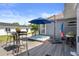 Backyard deck boasting a hot tub, umbrella-covered seating, and stylish decor for ultimate outdoor relaxation at 1209 W Adalee St, Tampa, FL 33603