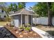 Charming backyard shed with a small stone path and nicely landscaped flower beds at 1209 W Adalee St, Tampa, FL 33603